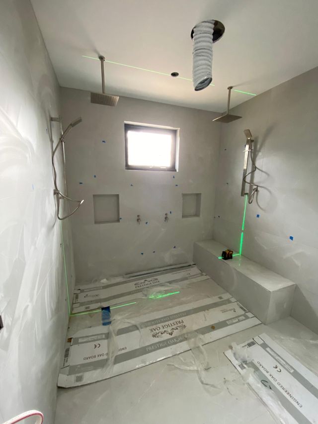 Bathroom rough-in with shower and tap outlets set out through the plasterboard, ready for tiling