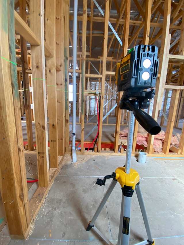 Plumbing rough-in set out with a laser level inside the timber frame of a new Melbourne home