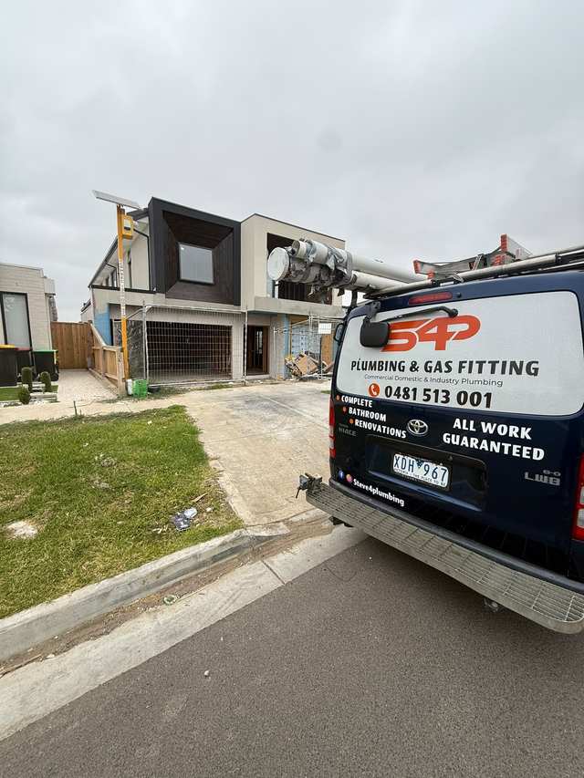 The S4P Plumbing and Gas Fitting van parked outside a new double-storey home under construction in Melbourne